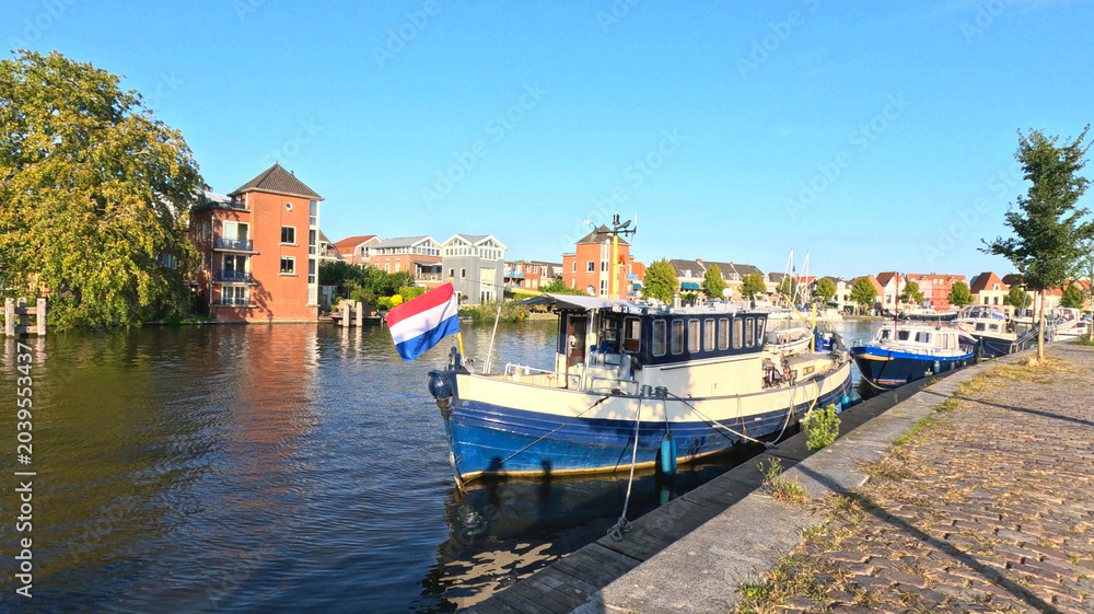 Obraz premium Moored Canal Boat with Dutch Flag on Haarlem Waterfront
