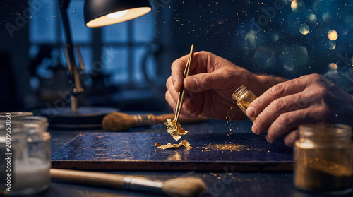 Картината върху платно Skilled hands meticulously work with delicate gold leaf and shimmering flakes, crafting precious decorations