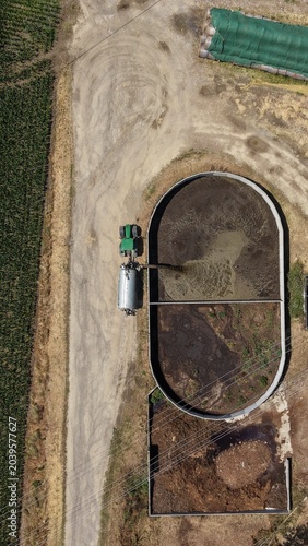 Foto Aerial view of a farm slurry pit with a tractor