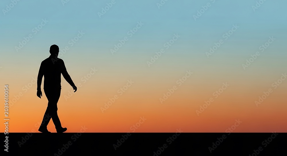 Fototapeta premium Man walking alone at sunset horizon.
