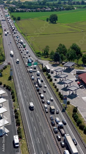 Traffic Jam on Highway: A vast, congested highway stretches into the distance, choked with an endless line of cars, trucks, and vans, creating a scene of automotive gridlock under a clear sky.