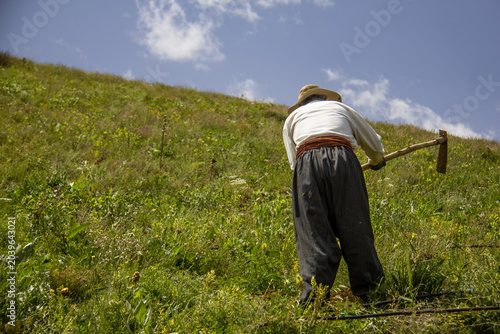 Bild auf Leinwand Kurdish Man Tending Garden Plants Outdoors