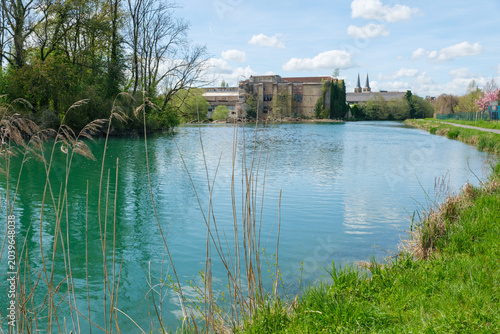 Photos View of the Meuse river in Mouzon in France with an abandoned factory in the bac