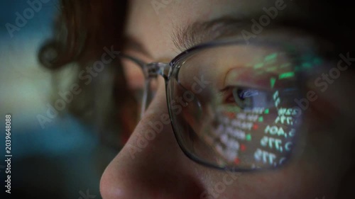 A young trader girl intently tracks real-time stock market fluctuations, her glasses reflecting the changing numbers on the screen, as she analyzes market trends with focus and precision