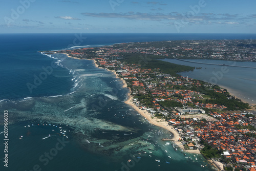Bild auf Leinwand Aerial view of Bali’s developed south coast with beaches, reef flats, hotels, boats, urban areas and the mangrove-lined bay near Denpasar, Indonesia