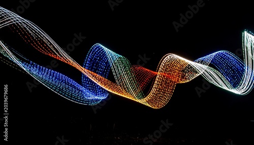 Colorful light trails form a dynamic wavy pattern against a stark black background