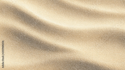 Close view of smooth beach sand with gentle patterns and warm light during summer day
