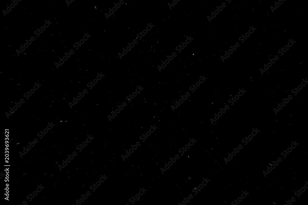 Fototapeta premium Particules beiges sur fond noir avec effet visuel de vitesse