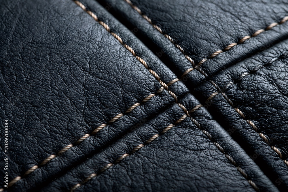 Naklejka premium Black leather surface showing detailed stitching texture