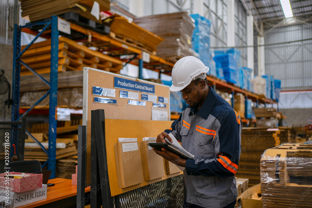 Fototapeta premium Factory Worker Using Digital Tablet at Production Control Board