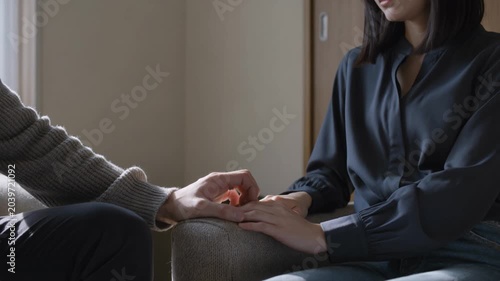 A Couple's Hands Touch Gently Offering Comfort and Support to Each Other