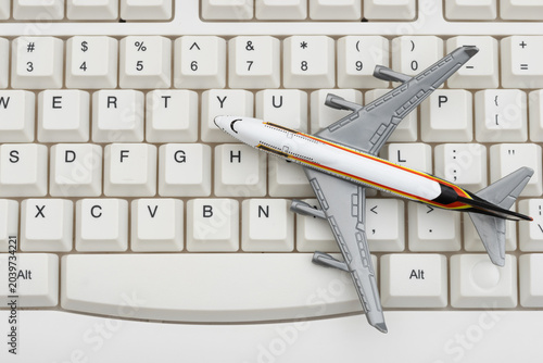 Cuadro en lienzo Airplane on a white computer keyboard for booking a flight online
