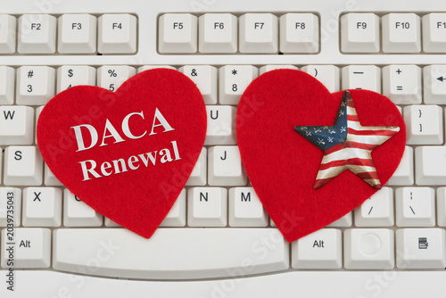 Tableau sur toile DACA Renewal text on red hearts with American flag star on a white computer keyb