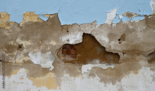 Bild auf Leinwand Horizontal close up of a decaying wall surface with peeling blue and white paint