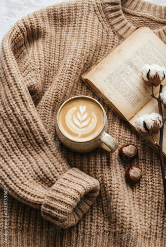 Minimalist lifestyle background with morning coffee and empty notebook copy space on beige textured wool blanket