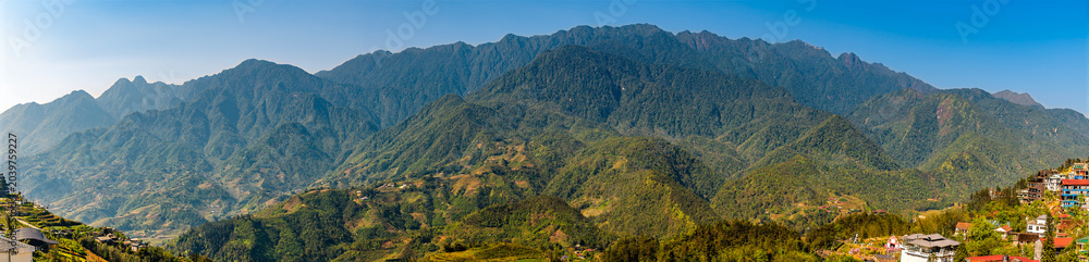 Fototapeta premium A panorama view across into the Muong Hoa Valley towards the Hoang Lien Son mountains from Sapa, Vietnam, in the morning