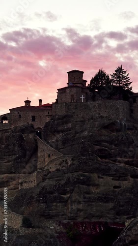 Monasteries of Meteora, Thessaly Greece. Time lapse of clouds moving across evening sky over monastery on rock formation. Place to visit. Vertical video