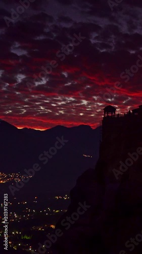 Monasteries of Meteora, Thessaly Greece. Time lapse of clouds moving across evening sky over holy Varlaam monastery on rock formation.  Vertical video