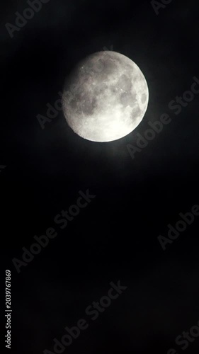 Full moon at night on black sky, moonlight. Vertical video