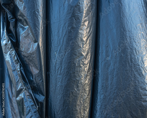 Black Crumpled Plastic Texture Background Provides Abstract Material Detail