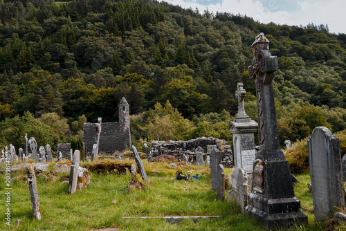 фотографія Ancient Celtic crosses and gravestones at Glendalough monastic site, Ireland
