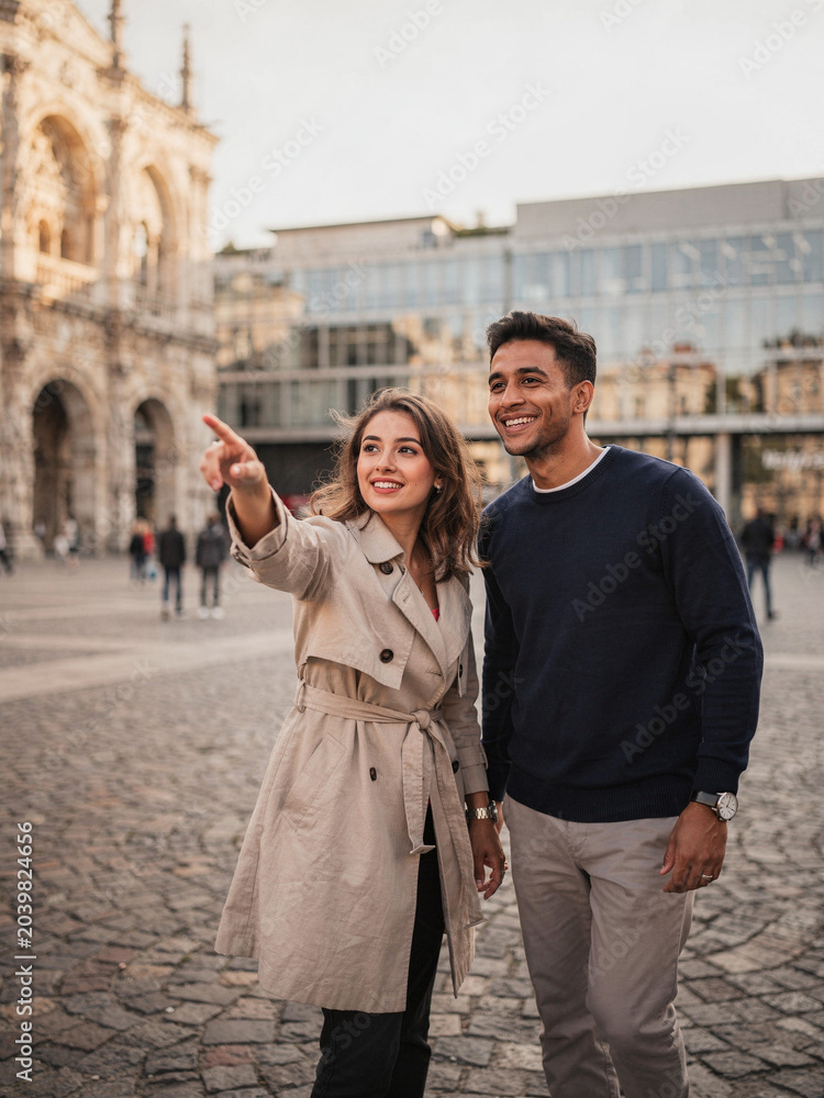 Fototapeta premium Happy Young Couple Sightseeing in a European City Square with Historic Architecture