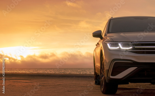 A gray SUV stands parked among the towering sand dunes of the Namib Desert under a dramatic cloudy sky. A bold visual of strength, solitude, and desert adventure.