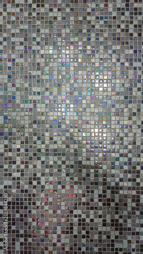 The background is made of very fine gray tiles. Wall in the bathroom. Geometric Abstraction of Small Squares