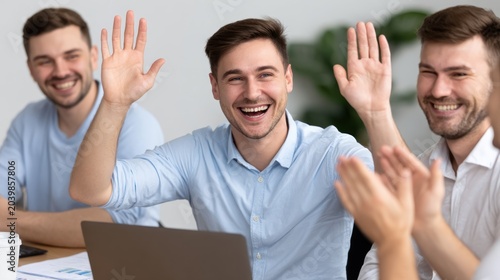 Happy Young Men Wearing Light Blue Shirts Smiling and High Fiving in Modern Office