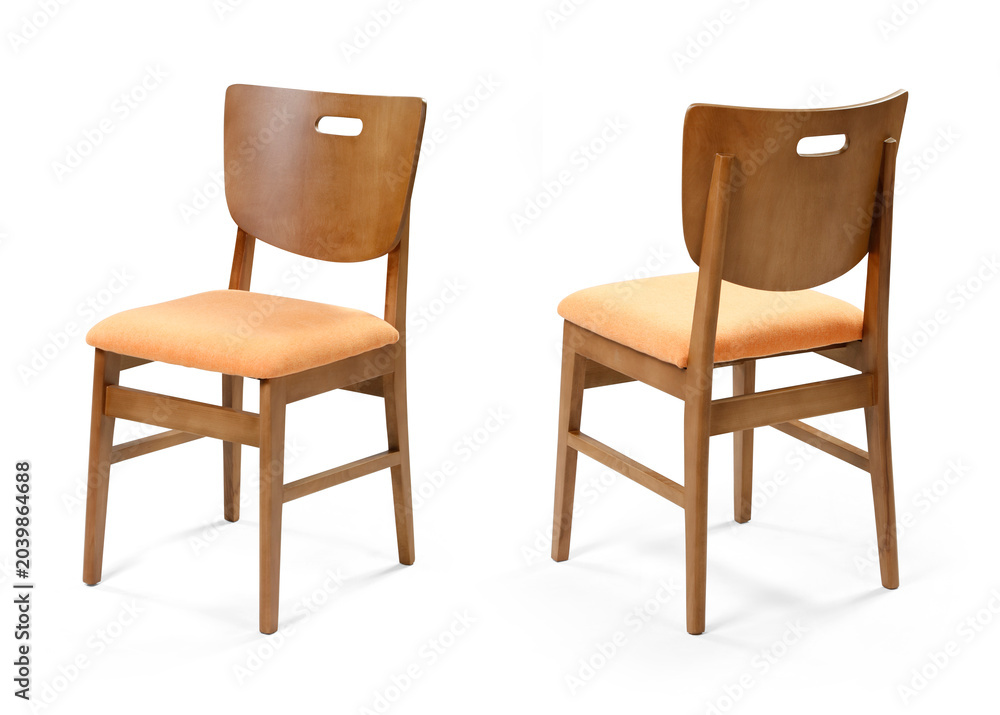 Obraz premium Front and back perspective views of a modern wooden dining chair with a peach fabric upholstered cushion and cutout backrest handle, isolated on a white background.