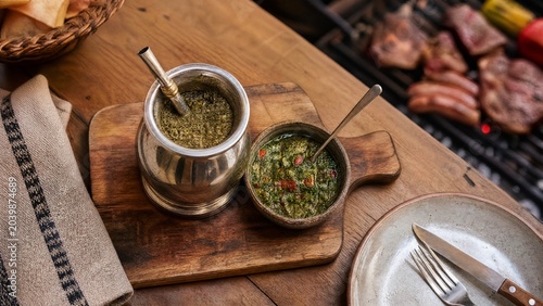 bombilla. Mate gourd and chimichurri on cutting board, Uruguayan asado dining concept. menu design, packaging mockups, designed for culinary blogs and recipe cards for restaurants.