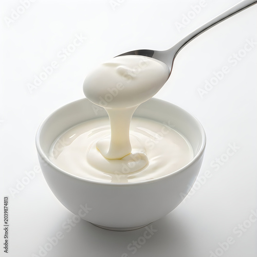 Spoonful of creamy yogurt in a white bowl