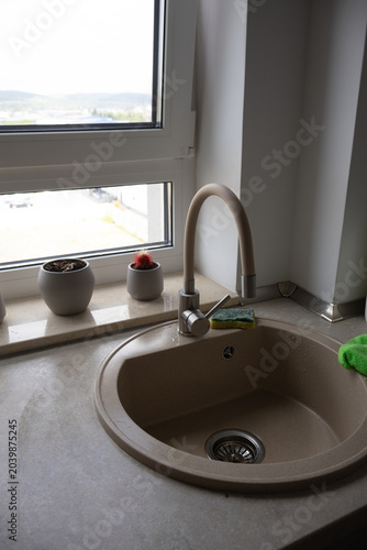 Vertical Shot of Composite Kitchen Sink Under Room Window
