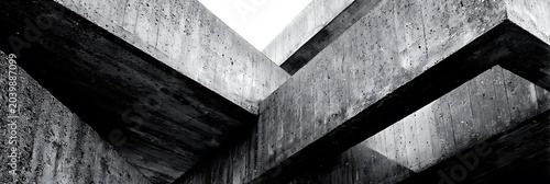 Brutalist concrete architecture with massive geometric beams and industrial textures captured in high contrast black and white style for modern urban design projects