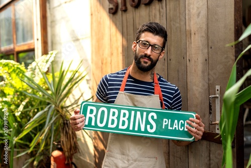 Photography Man holding street sign outdoors.