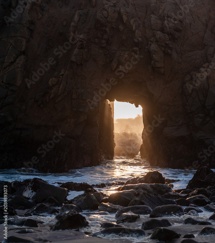 Photos Detail of the Keyhole arch at Pfeiffer beach, with the setting sun to be just behind it