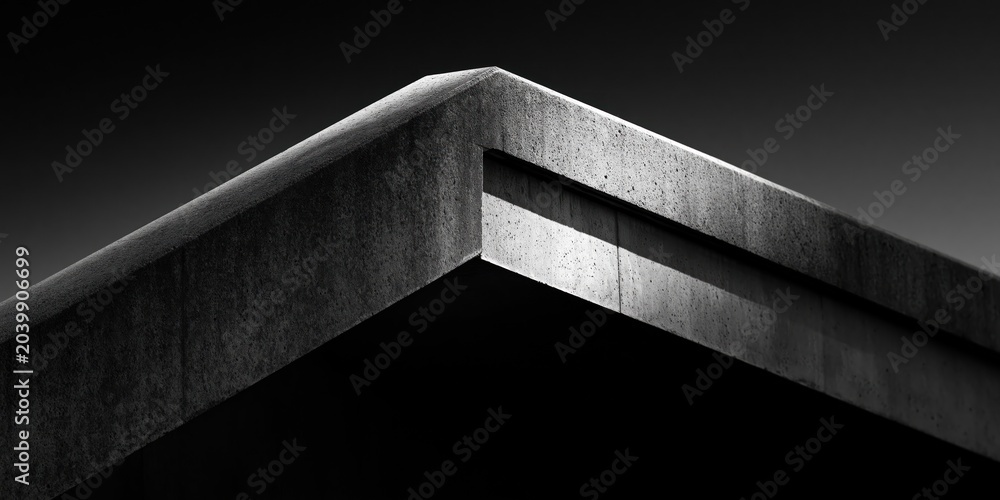 Naklejka premium A striking close-up of a concrete corner in architectural design, emphasizing sharp lines and modern aesthetics, showcasing contemporary industrial style.