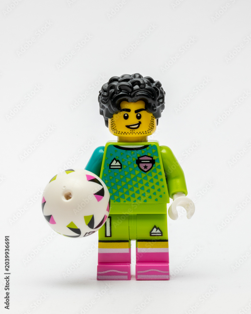 Obraz premium A minifigure of a footballer holding a football