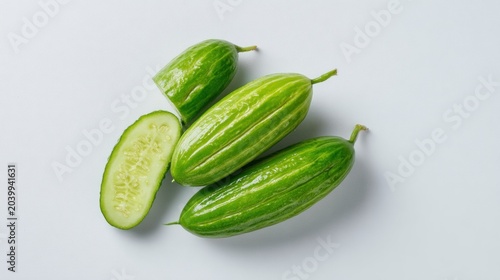 Several fresh, ribbed, green produce items are displayed on a light surface