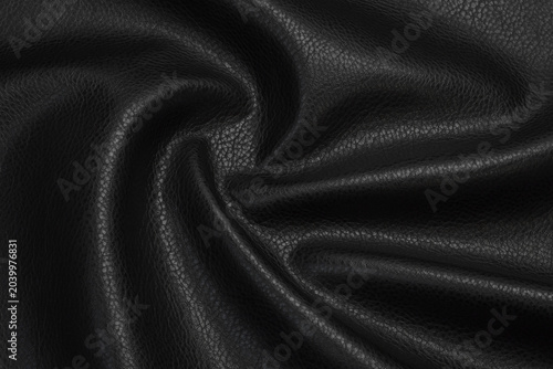 black artificial leather with waves and folds on PVC base