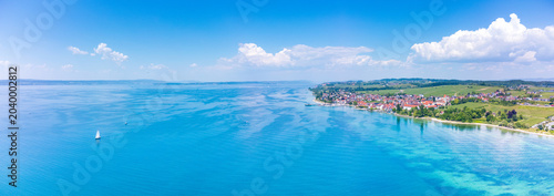 Stunning aerial panoramic shot capturing Hagnau village and the vast waters of Lake Constance.