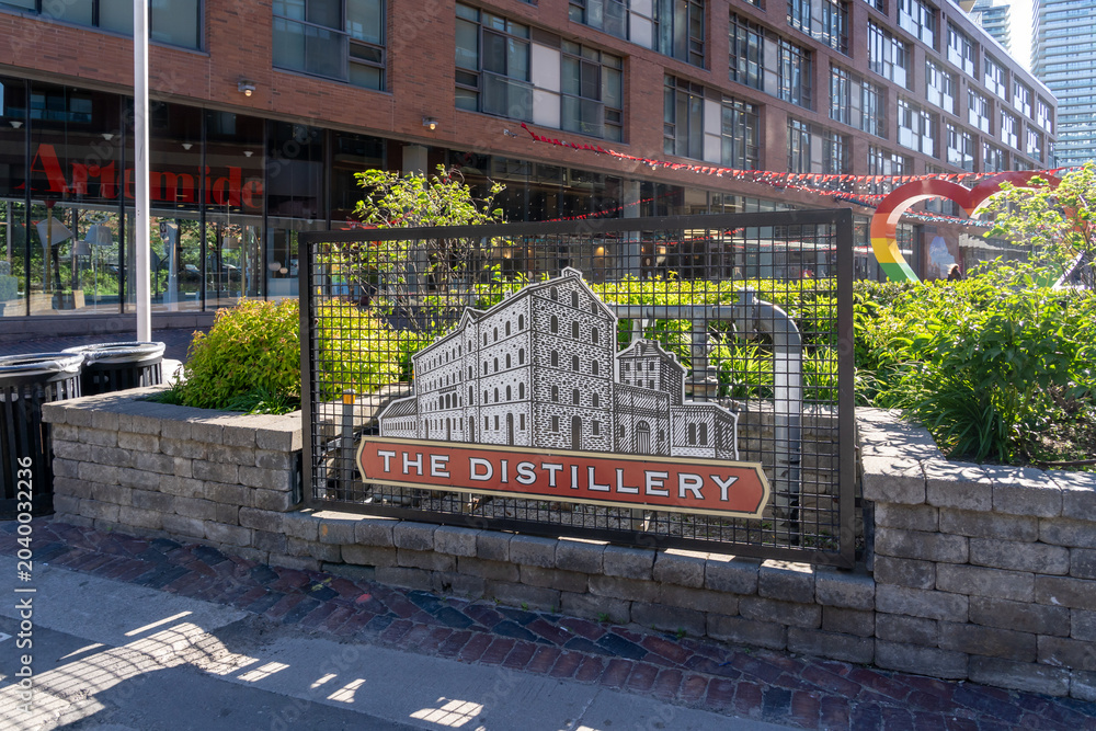 Naklejka premium Toronto, Canada - May 30, 2026: The entrance to The Distillery Historic District in Toronto, Canada in 2026. The Distillery Historic District is one of Toronto's most unique shopping, culinary, arts a