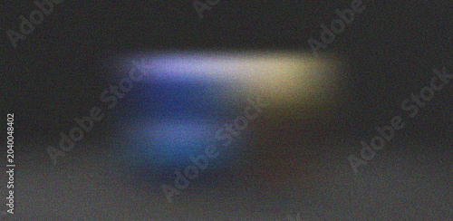 Fotografía Dark atmospheric grainy surface with subtle blue and yellow light streaks creati