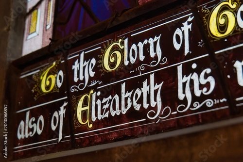 Bild auf Leinwand stained glass panel with illuminated, decorative script at Gloucester Cathedral
