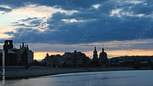 A picturesque embankment in the center of Yoshkar-Ola city at sunset with fabulous architecture and domes of the Annunciation Cathedral against a picturesque cloudy sky. Russia
