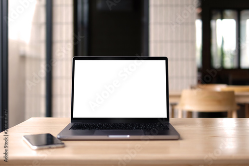 A front view showing a laptop on a table and a mobile phone.