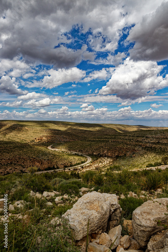 Winding Desert Road Under a Dynamic Sky