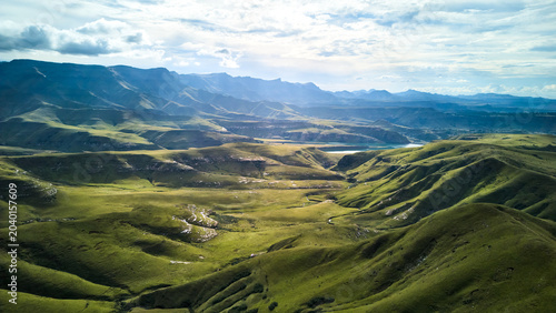 Aerial View Rolling Green Hills South Africa, Expansive Undulating Grassland Bathed In Golden Morning Light,