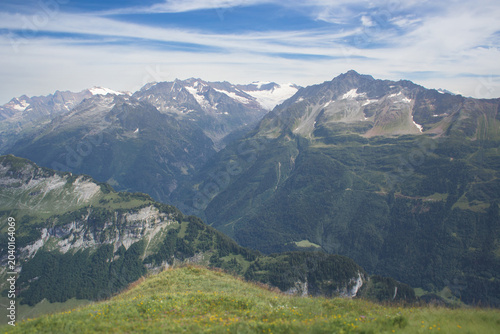 Rugged alpine peaks and mountain ranges under a cloudy sky