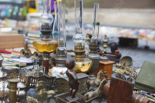Schilderij op canvas Vintage kerosene lamps and trinkets at an outdoor flea market